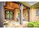 Charming front porch with brick columns, seating, and double front doors create a welcoming entrance at 4600 Spicewood Dr, Charlotte, NC 28227