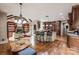 Open kitchen with granite countertops, stainless steel appliances, an island with barstool seating, and adjacent living area at 4600 Spicewood Dr, Charlotte, NC 28227