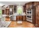 Kitchen featuring stainless steel appliances, wooden cabinets, and granite countertops at 4600 Spicewood Dr, Charlotte, NC 28227