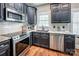 Close-up of modern kitchen with stainless steel appliances, granite countertops, and subway tile backsplash at 4600 Spicewood Dr, Charlotte, NC 28227
