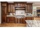 Kitchen with a range and hood, granite countertops, stainless steel appliances and wood cabinets at 4600 Spicewood Dr, Charlotte, NC 28227