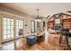 Living space with french doors to the backyard, hardwood floors, and exposed wood beams on the ceiling at 4600 Spicewood Dr, Charlotte, NC 28227