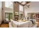 A bright, expansive living room features a striking stone fireplace, hardwood floors, and abundant natural light at 4600 Spicewood Dr, Charlotte, NC 28227