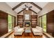 Cozy living room showcasing a stone fireplace, built-in shelving, hardwood floors, and abundant natural light at 4600 Spicewood Dr, Charlotte, NC 28227