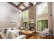 Grand living room with soaring ceilings, a stone fireplace, hardwood floors and ample natural light at 4600 Spicewood Dr, Charlotte, NC 28227