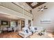 Spacious living room featuring a fireplace, second story railing, and beautiful hardwood floors at 4600 Spicewood Dr, Charlotte, NC 28227