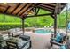 Relaxing poolside patio with comfortable seating, hot tub, and covered outdoor area, perfect for entertaining at 4600 Spicewood Dr, Charlotte, NC 28227