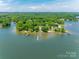 Lakefront property featuring lush greenery, several docks, and stunning water views on a clear, sunny day at 5200 Masons Ferry Rd, Clover, SC 29710
