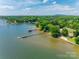 Aerial view of waterfront property with multiple docks and lush greenery at 5200 Masons Ferry Rd, Clover, SC 29710