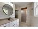 Bathroom featuring a custom vanity with a large circular mirror, modern fixtures, and glass enclosed shower at 5200 Masons Ferry Rd, Clover, SC 29710