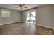 Bedroom featuring hardwood floors and sliding door access to outdoor patio and lake views at 5200 Masons Ferry Rd, Clover, SC 29710