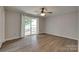 Bedroom featuring a ceiling fan, sliding glass door with water view, and hardwood floors at 5200 Masons Ferry Rd, Clover, SC 29710