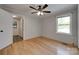 Bedroom with natural light, hardwood floors, a ceiling fan, and an exterior door at 5200 Masons Ferry Rd, Clover, SC 29710