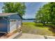 Home exterior featuring a two-car garage, lake, and dock at 5200 Masons Ferry Rd, Clover, SC 29710