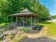 Outdoor gazebo with wood beams, white furnishings, and manicured landscaping at 5200 Masons Ferry Rd, Clover, SC 29710