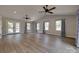 Bright living room features hardwood floors, vaulted ceilings, modern ceiling fans, and access to outdoor spaces at 5200 Masons Ferry Rd, Clover, SC 29710