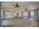 Bright, open living room with hardwood floors, vaulted ceiling, ceiling fans, and seamless transition to adjacent spaces at 5200 Masons Ferry Rd, Clover, SC 29710