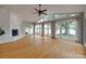 Living room featuring hardwood floors, ceiling fan, and scenic water views at 5200 Masons Ferry Rd, Clover, SC 29710