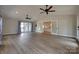 Spacious living room featuring hardwood floors, a vaulted ceiling, modern ceiling fans, and French doors to other rooms at 5200 Masons Ferry Rd, Clover, SC 29710