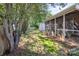 The backyard features a screened-in porch, storage shed, mature trees and a partial fence for privacy at 5804 Crosswinds Ct, Indian Trail, NC 28079