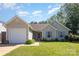 Charming single-story home with a well-maintained lawn, inviting entrance, and a convenient attached garage at 5804 Crosswinds Ct, Indian Trail, NC 28079