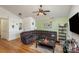 Cozy living room with hardwood floors, large sectional couch, modern lighting, and neutral paint at 5804 Crosswinds Ct, Indian Trail, NC 28079