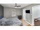 Comfortable bedroom features neutral gray tones, hardwood flooring, and a ceiling fan at 5804 Crosswinds Ct, Indian Trail, NC 28079