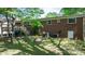 View of a brick home's backyard with a deck, grill, and some foliage at 634 7Th Avenue Se Pl, Hickory, NC 28602