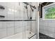 Modern bathtub with a glass shower enclosure and white subway tile surround at 634 7Th Avenue Se Pl, Hickory, NC 28602