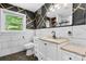 Stylish bathroom with a white vanity, modern fixtures, and geometric-patterned accent wall at 634 7Th Avenue Se Pl, Hickory, NC 28602