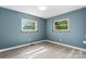 An empty bedroom with two large windows and newly installed flooring showcasing natural light at 634 7Th Avenue Se Pl, Hickory, NC 28602