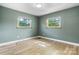 A comfortable bedroom with freshly installed floors, two windows, and neutral-colored walls at 634 7Th Avenue Se Pl, Hickory, NC 28602