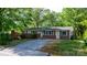 A cozy one-story home with brick facade and light siding, complemented by a gravel driveway at 634 7Th Avenue Se Pl, Hickory, NC 28602