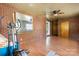 Spacious room with red brick walls, a ceiling fan, and hardwood flooring at 634 7Th Avenue Se Pl, Hickory, NC 28602