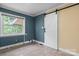 Well-lit bonus room with a modern sliding barn door and neutral tile flooring at 634 7Th Avenue Se Pl, Hickory, NC 28602