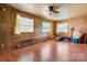 Large bonus room featuring paneled walls, natural light, and laminate wood flooring at 634 7Th Avenue Se Pl, Hickory, NC 28602