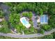 Overhead view of community pool, parking, tennis courts, and trees surrounding a lake at 6425 High Creek Ct, Charlotte, NC 28277