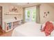 Bright bedroom with a built-in desk, white shelving, and window that provides an abundance of natural light at 6425 High Creek Ct, Charlotte, NC 28277