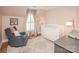 Lovely Bedroom features soft pink walls, a rocking chair, and a crib for a tranquil space at 6425 High Creek Ct, Charlotte, NC 28277