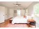 Bedroom with hardwood floors, ceiling fan, ensuite bath with barn door, and neutral paint at 6425 High Creek Ct, Charlotte, NC 28277