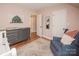 Cozy Bedroom offers soft pink walls, wood flooring, a recliner, a dresser, and a baby changing table at 6425 High Creek Ct, Charlotte, NC 28277