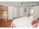 Bedroom featuring hardwood floors, vaulted ceilings, neutral paint, and access to an upstairs landing at 6425 High Creek Ct, Charlotte, NC 28277