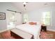 Bright bedroom features vaulted ceilings, hardwood floors, and an ensuite bathroom with a sliding barn door at 6425 High Creek Ct, Charlotte, NC 28277