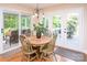 A sunny breakfast nook with light wood floors and access to the screened porch and back deck at 6425 High Creek Ct, Charlotte, NC 28277
