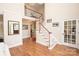 Inviting foyer with hardwood floors, staircase with white railing, and elegant decor at 6425 High Creek Ct, Charlotte, NC 28277