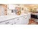 A bright kitchen featuring stainless steel appliances, white cabinets, granite countertops, and an island at 6425 High Creek Ct, Charlotte, NC 28277