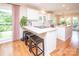Bright kitchen featuring a breakfast bar with seating, stainless steel appliances, and hardwood floors at 6425 High Creek Ct, Charlotte, NC 28277