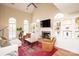 Spacious living room featuring a fireplace, large windows, hardwood flooring, and ample seating at 6425 High Creek Ct, Charlotte, NC 28277