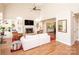 Bright living room with vaulted ceilings, hardwood floors, built-in shelving, and a cozy fireplace at 6425 High Creek Ct, Charlotte, NC 28277