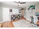 Home office featuring hardwood floors, white shelving, a white board, and dark trim at 6425 High Creek Ct, Charlotte, NC 28277